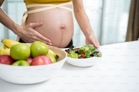 妊婦さんが食事をとろうとしています。
